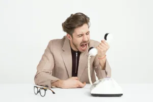 angry employee yelling into phone